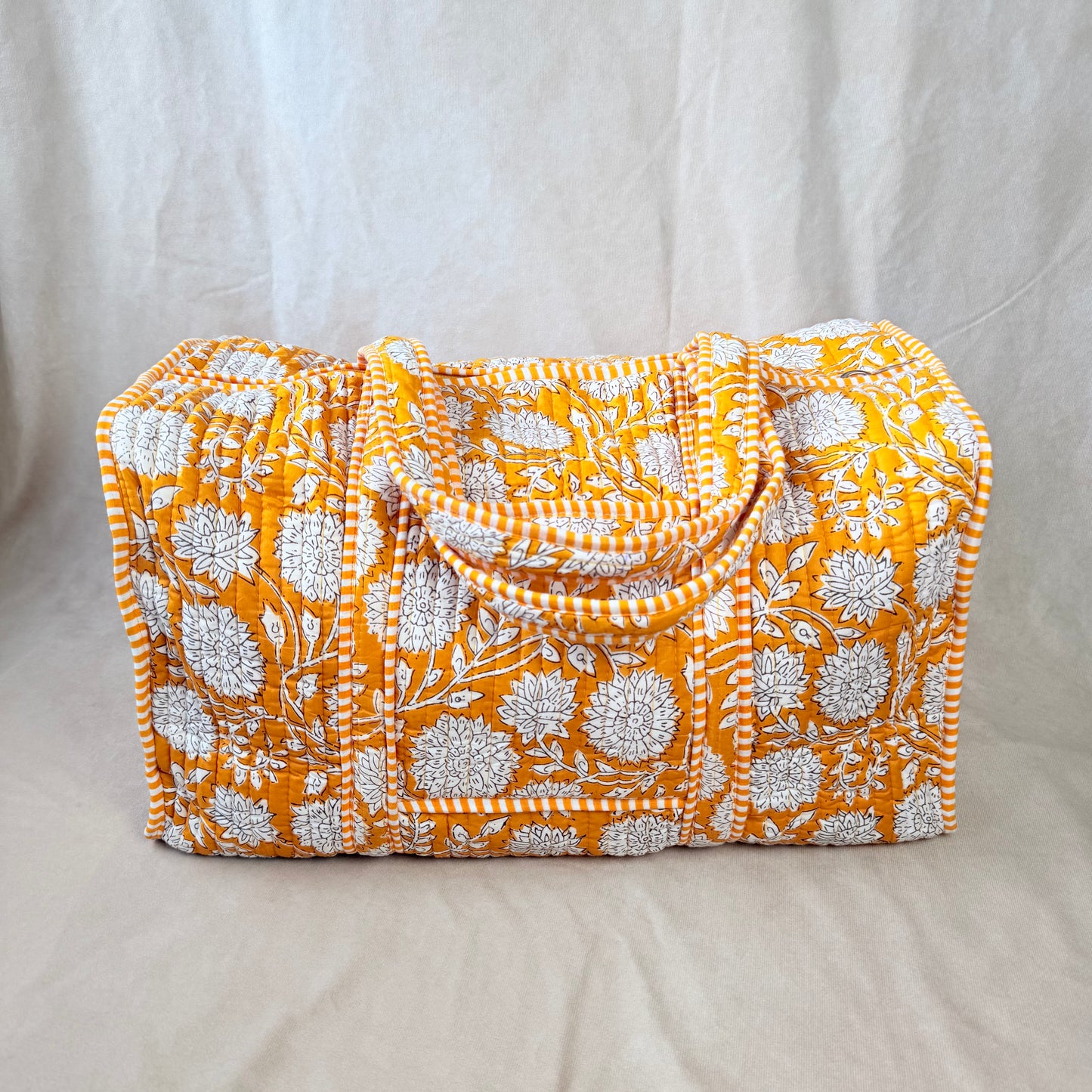 Mustard-gold floral print quilted cotton duffel bag for travel