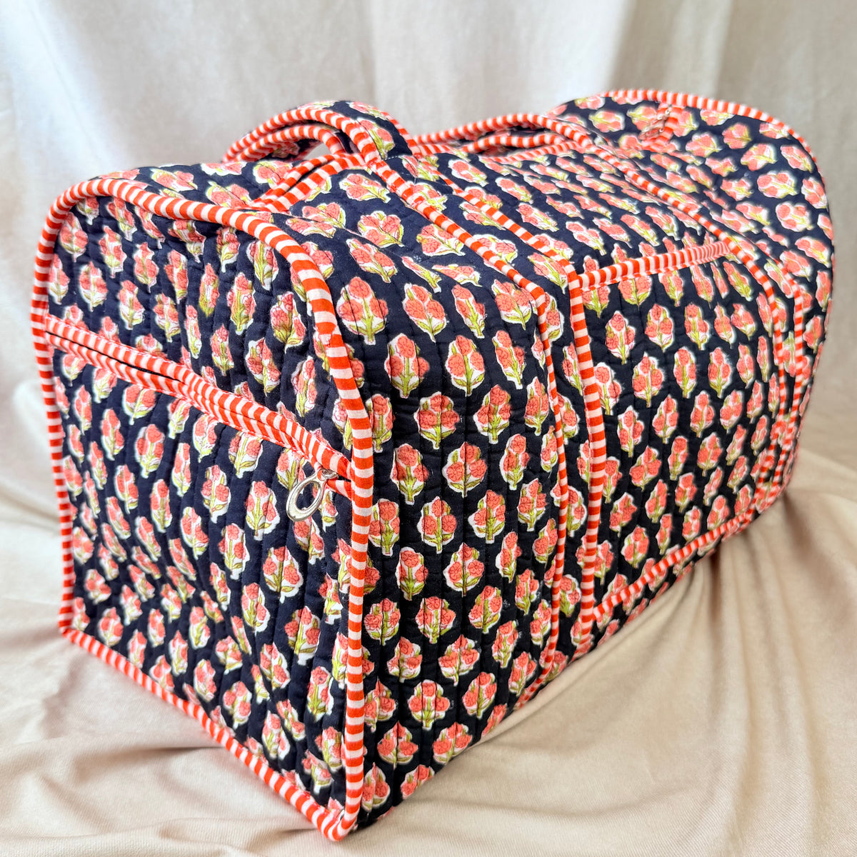 Black and orange floral print quilted cotton duffel bag