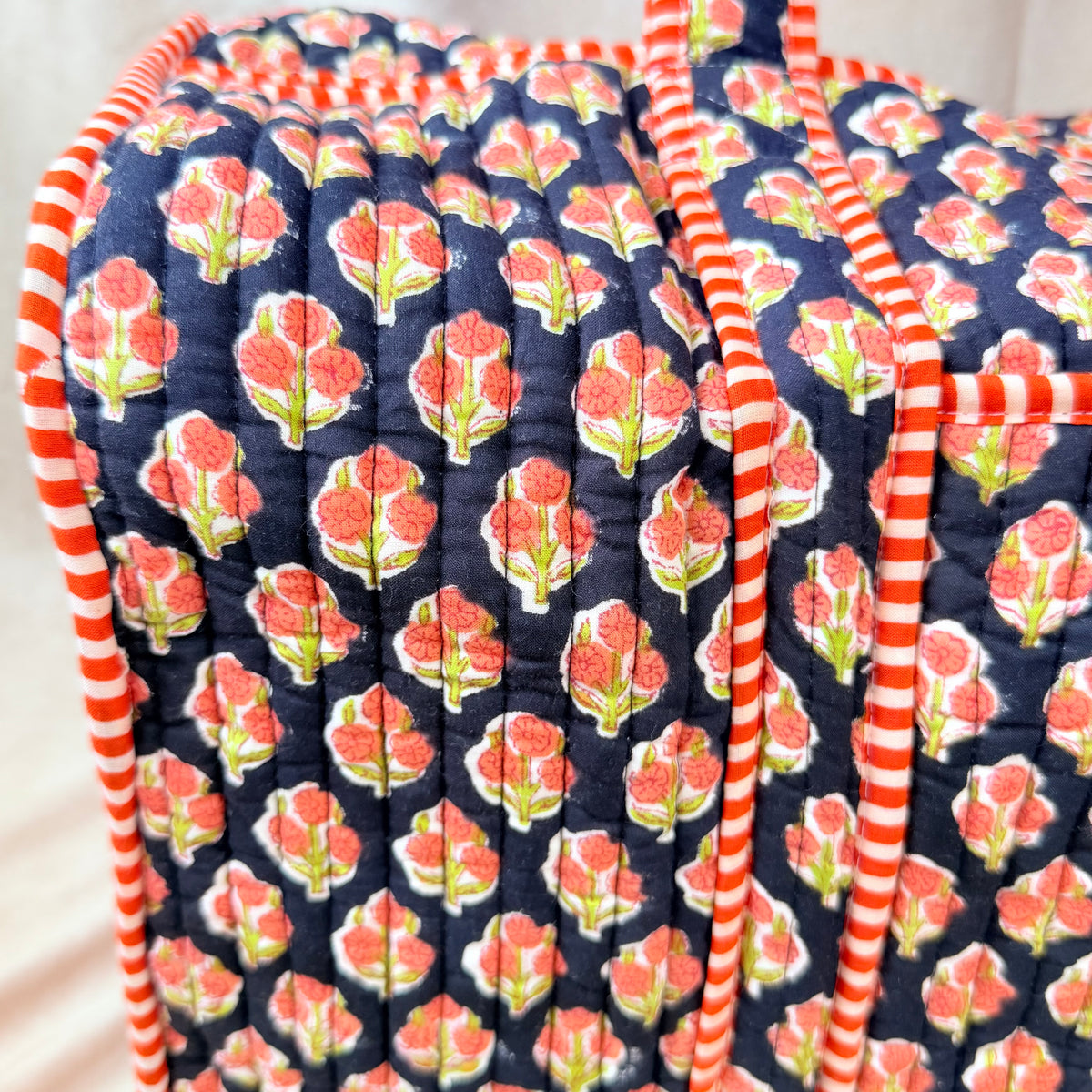 Black and orange floral print quilted cotton duffel bag