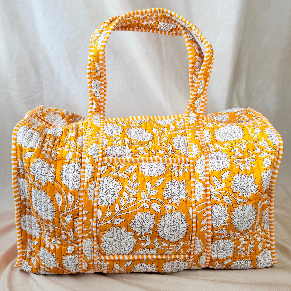 Mustard-gold floral print quilted cotton duffel bag for travel