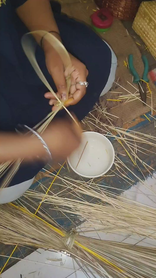 Video showing colorful handwoven Sikki grass round mats